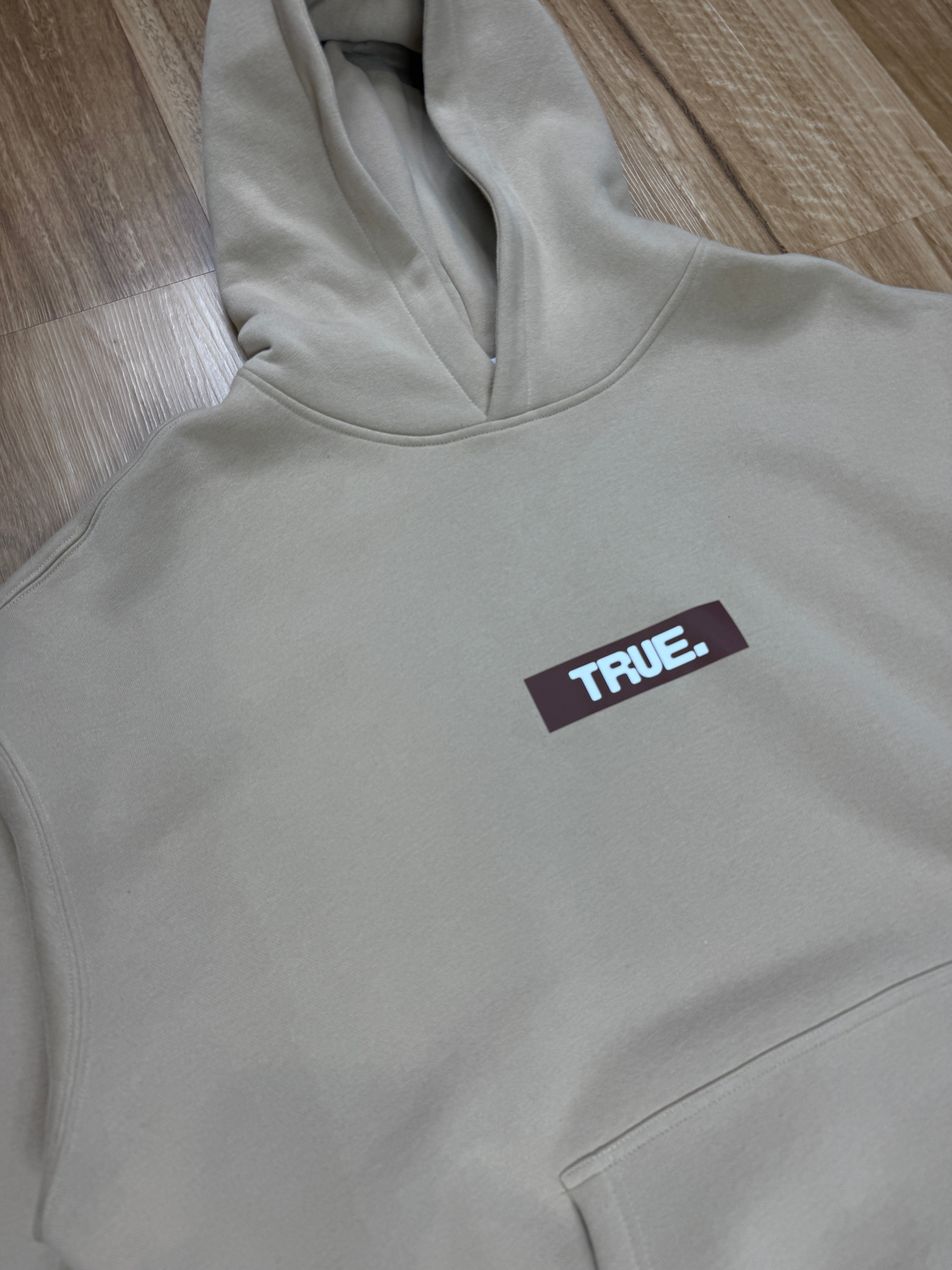 Oversized Sand Fleece Unisex Hoodie with Chocolate TRUE. Design