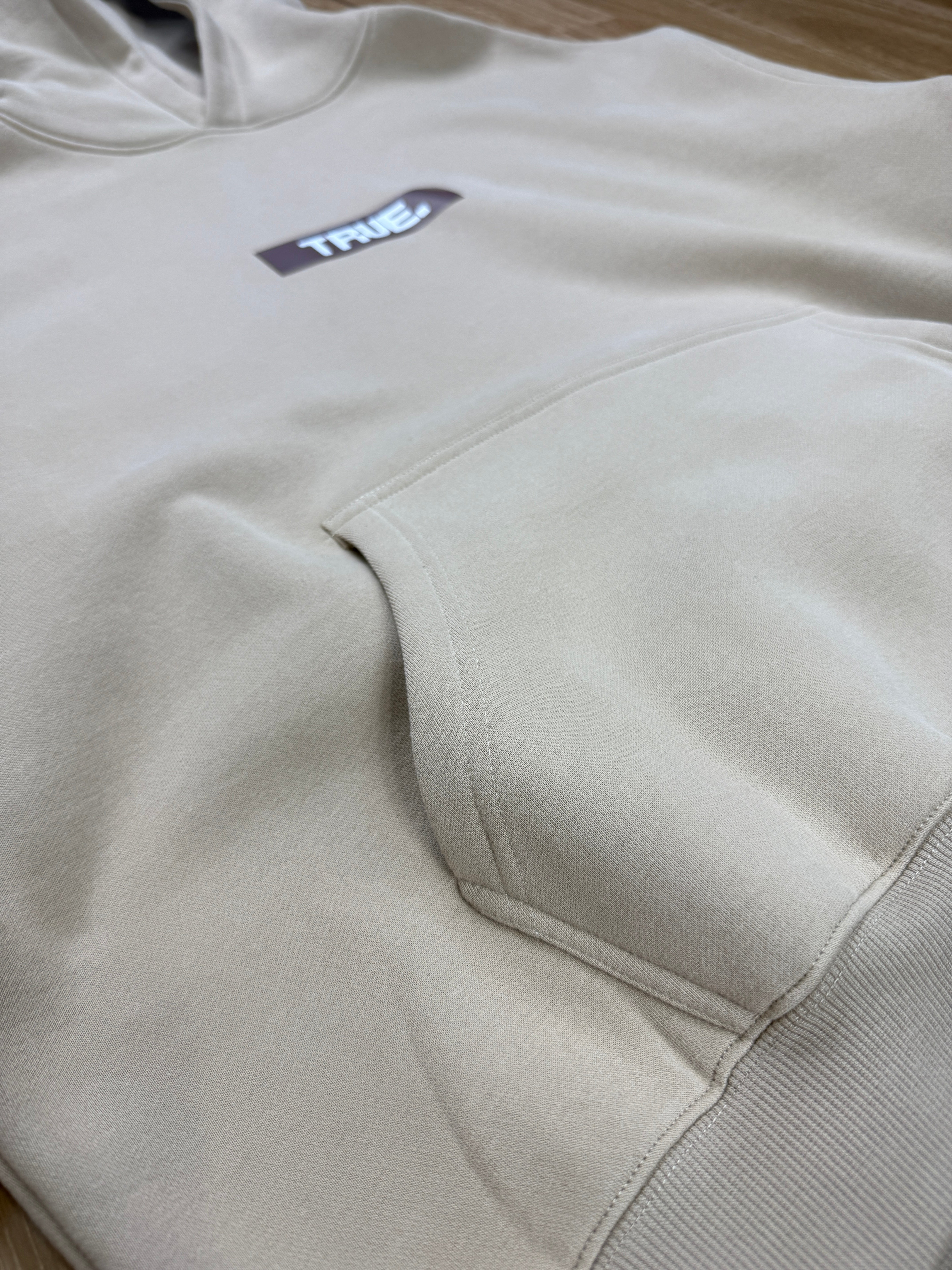 Oversized Sand Fleece Unisex Hoodie with Chocolate TRUE. Design