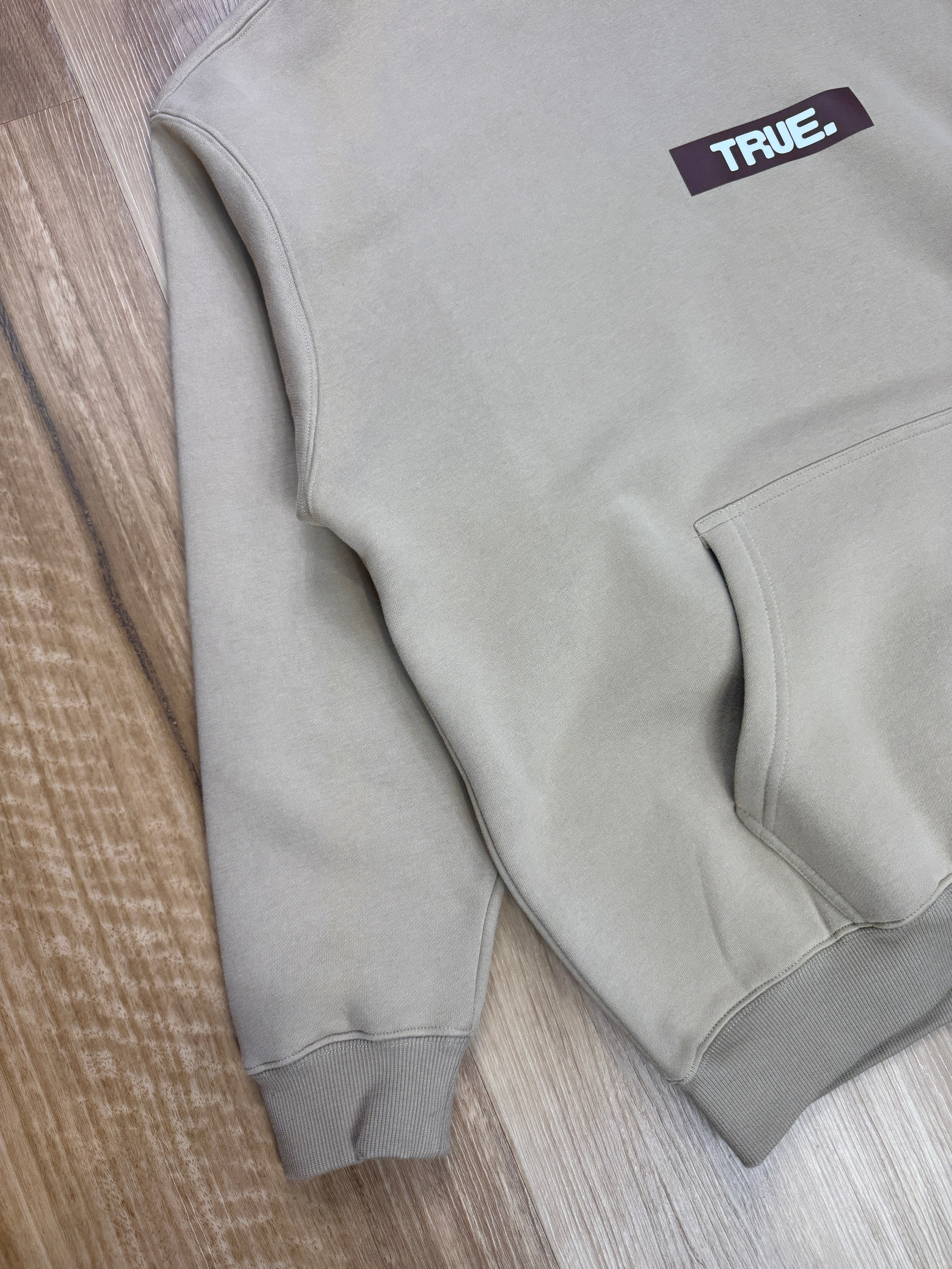 Oversized Sand Fleece Unisex Hoodie with Chocolate TRUE. Design
