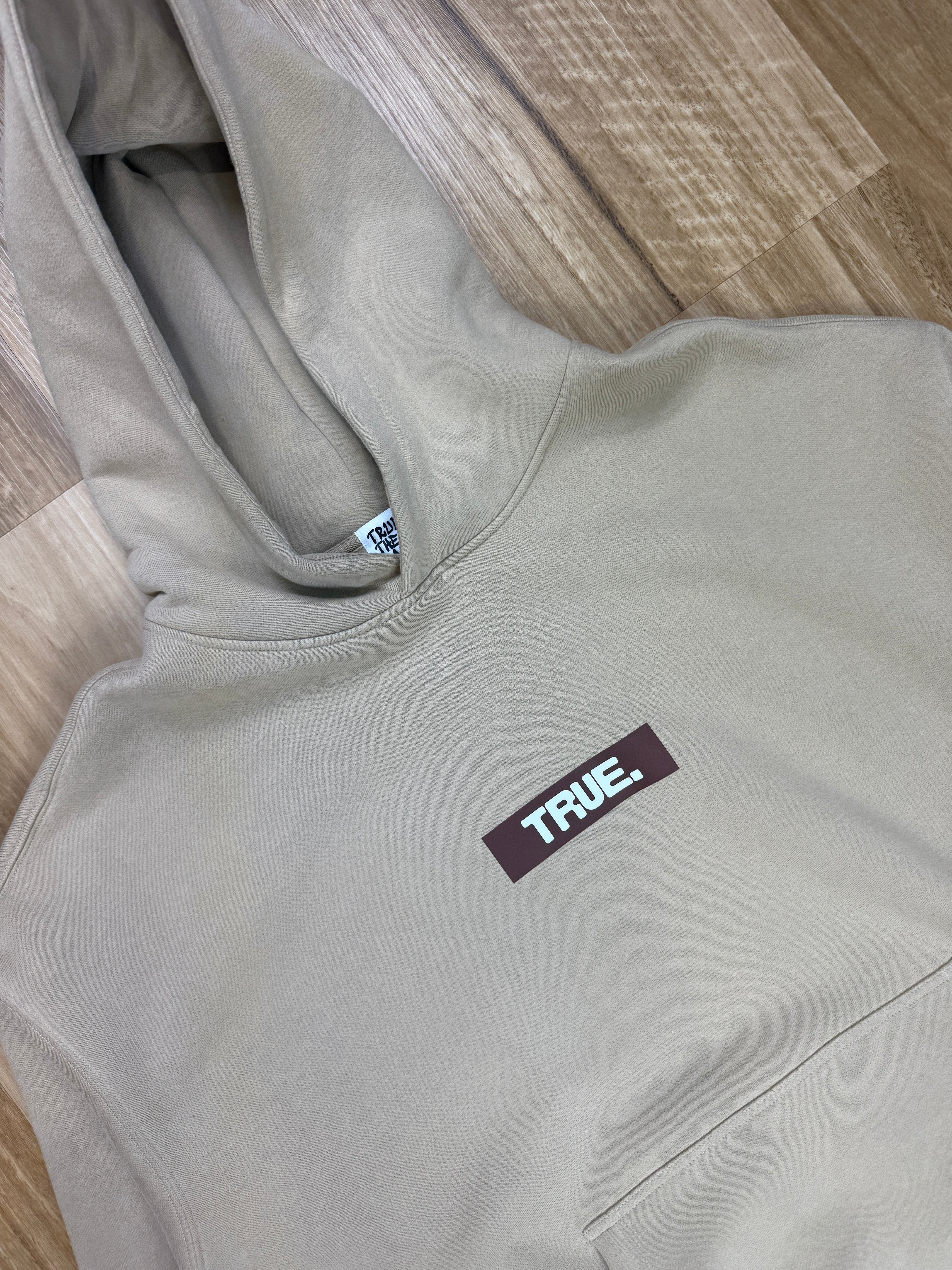 Oversized Sand Fleece Unisex Hoodie with Chocolate TRUE. Design