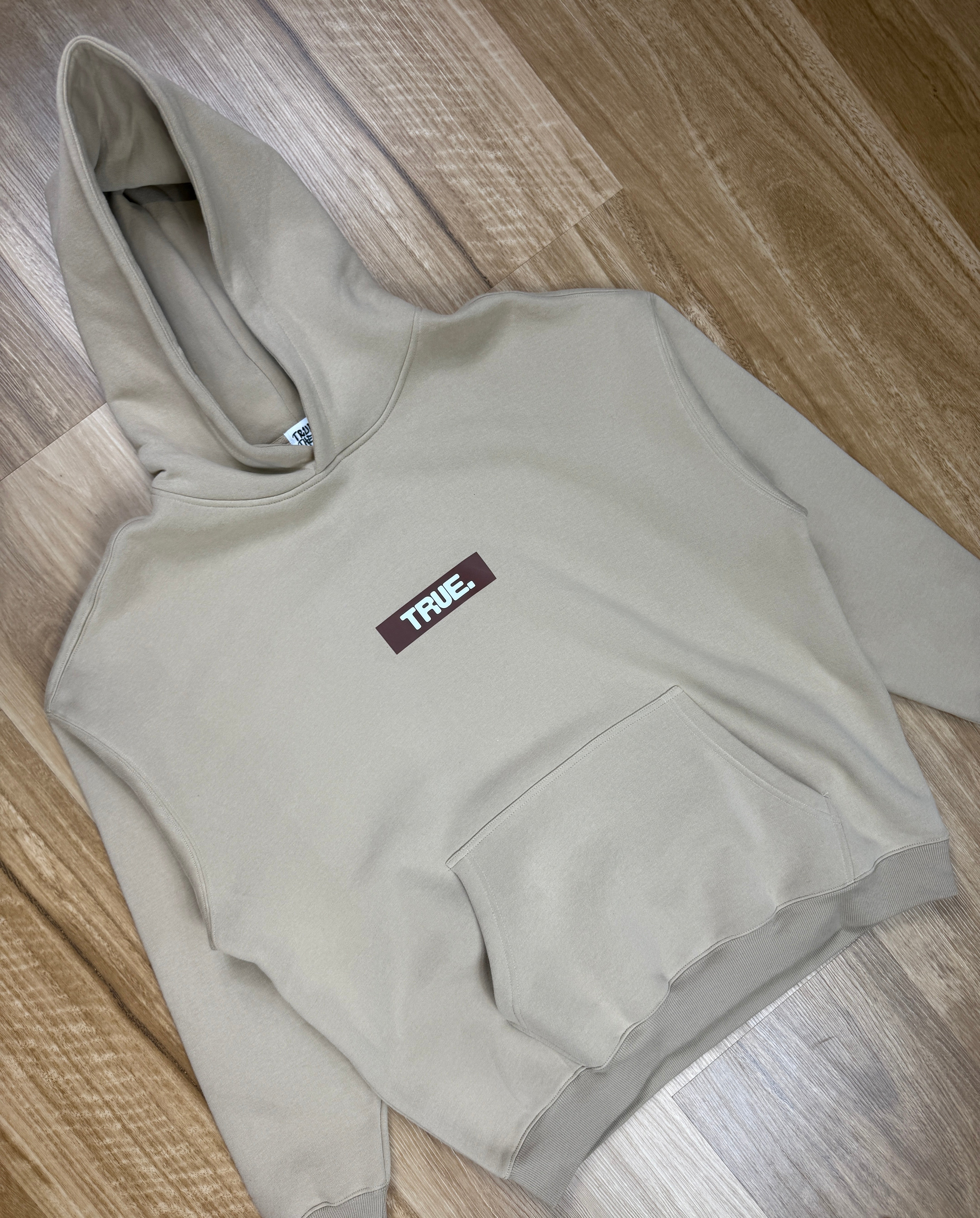 Oversized Sand Fleece Unisex Hoodie with Chocolate TRUE. Design